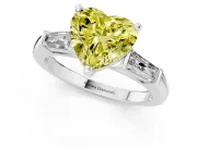 Fancy Yellow Heart Cut Diamond Solitaire Ring Set in Platinum with Tapered Baguette Side Stones and Prong Setting