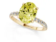 Fancy Yellow Oval Cut Diamond Solitaire Ring Set in Yellow gold with Round Pavé Band and Prong Setting