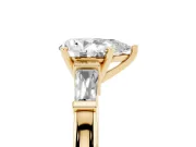 Pear Cut Diamond Solitaire Ring Set in Yellow gold with Tapered Baguette Accents and Prong Setting