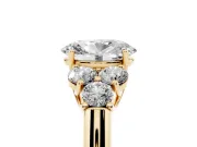 Oval Cut Diamond Cluster Ring Set in Yellow gold with Round Accent Stones and Prong Setting on a Plain Band