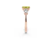 Fancy Yellow Three-Stone Emerald Cut Diamond Ring Set in Rose gold with Pear Side Stones and Prong Setting