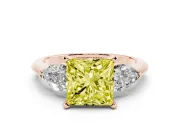Fancy Yellow Three-Stone Princess Cut Diamond Ring Set in Rose gold with Pear Side Stones and Prong Setting