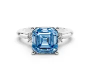 Fancy Blue Three-Stone Asscher Cut Diamond Ring Set in Platinum with Prong Setting and Plain Band
