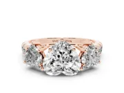 Heart Cut Diamond Three-Stone Ring Set in Rose gold with Pavé Band
