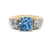 Fancy Blue Cushion Cut Diamond Three-Stone Ring Set in Yellow gold with Pavé Band