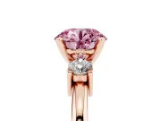 Fancy Pink Three-Stone Round Cut Diamond Ring Set in Rose gold with Prong Setting and Plain Band