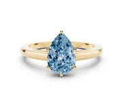 Fancy Blue Pear Cut Diamond Solitaire Engagement Ring Set in Yellow gold with Prong Setting on a Classic Band
