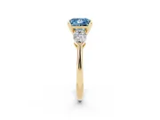 Fancy Blue Three-Stone Princess Cut Diamond Ring Set in Yellow gold with Pear Side Stones and Prong Setting