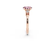 Fancy Pink Three-Stone Oval Cut Diamond Ring Set in Rose gold with Prong Setting and Plain Band