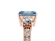 Fancy Blue Emerald Cut Diamond Three-Stone Ring Set in Rose gold with Round Side Stones and Pavé Band