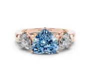 Fancy Blue Heart Cut Diamond Three-Stone Ring Set in Rose gold with Bold Center and Classic Band