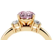 Fancy Pink Three-Stone Oval Cut Diamond Ring Set in Yellow gold with Prong Setting and Plain Band