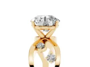 Round Cut Diamond Solitaire Ring Set in Yellow gold with Side Stones on Criss-Cross Band and Prong Setting