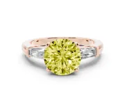 Fancy Yellow Round Cut Diamond Solitaire Ring Set in Rose gold with Tapered Baguette Side Stones and Prong Setting