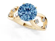Fancy Blue Round Cut Diamond Solitaire Ring Set in Yellow gold with Side Stones on Criss-Cross Band and Prong Setting
