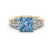 Fancy Blue Princess Cut Diamond Cluster Ring Set in Yellow gold with Round Accent Stones and Prong Setting on a Plain Band