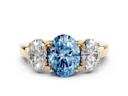 Fancy Blue Oval Cut Diamond Three-Stone Ring Set in Yellow gold with Polished Band and Prong Setting