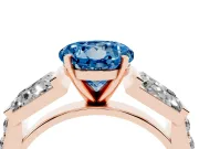 Fancy Blue Round Cut Diamond Engagement Ring Set in Rose gold with Baguette Side Stones and Channel Set Band