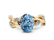 Fancy Blue Oval Cut Diamond Solitaire Ring Set in Yellow gold with Twisted Marquise Accent Band