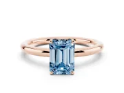 Fancy Blue Emerald Cut Diamond Solitaire Ring Set in Rose gold with Prong Setting on a Polished Plain Band