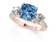Fancy Blue Three-Stone Cushion Cut Diamond Pavé Band Ring Set in Rose gold with Prong-Set Trio