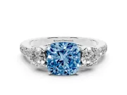 Fancy Blue Cushion Cut Diamond Three-Stone Ring Set in White gold with Round Side Stones and Delicate Pavé Band