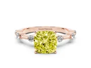 Fancy Yellow Cushion Cut Diamond Solitaire Ring Set in Rose gold with Bezel Set Side Stones and Prong Setting