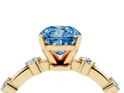 Fancy Blue Cushion Cut Diamond Solitaire Ring Set in Yellow gold with Bezel Set Side Stones and Prong Setting