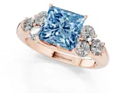 Fancy Blue Princess Cut Diamond Cluster Ring Set in Rose gold with Round Accent Stones and Prong Setting on a Plain Band