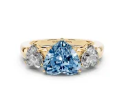 Fancy Blue Heart Cut Diamond Three-Stone Ring Set in Yellow gold with Bold Center and Classic Band