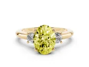 Fancy Yellow Three-Stone Oval Cut Diamond Ring Set in Yellow gold with Prong Setting and Plain Band