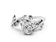 Oval Cut Diamond Solitaire Twist Engagement Ring Set in White gold with Pavé Leaf Accents