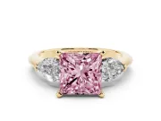 Fancy Pink Three-Stone Princess Cut Diamond Ring Set in Yellow gold with Pear Side Stones and Prong Setting