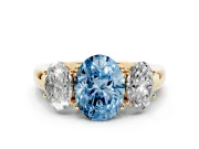 Fancy Blue Oval Cut Diamond Three-Stone Ring Set in Yellow gold with Bold Center and Classic Band