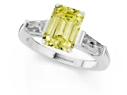 Fancy Yellow Emerald Cut Diamond Solitaire Ring Set in Platinum with Tapered Baguette Side Stones and Prong Setting