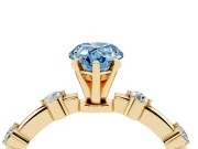 Fancy Blue Pear Cut Diamond Solitaire Ring Set in Yellow gold with Bezel Set Side Stones and Prong Setting