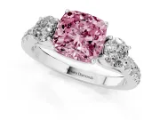 Fancy Pink Cushion Cut Diamond Three-Stone Ring Set in Platinum with Round Side Stones and Delicate Pavé Band