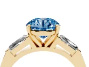 Fancy Blue Round Cut Diamond Solitaire Ring Set in Yellow gold with Tapered Baguette Side Stones and Prong Setting