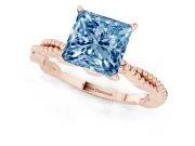 Fancy Blue Princess Cut Diamond Solitaire Ring Set in Rose gold with Twisted Band and Bead Prong Setting