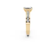 Emerald Cut Diamond Solitaire Ring Set in Yellow gold with Channel-Set Band and Prong Setting
