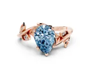 Fancy Blue Pear Cut Diamond Solitaire Twist Engagement Ring Set in Rose gold with Pavé Leaf Accents