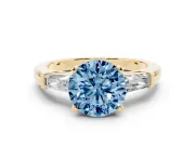 Fancy Blue Round Cut Diamond Solitaire Ring Set in Yellow gold with Tapered Baguette Side Stones and Prong Setting