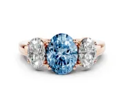 Fancy Blue Oval Cut Diamond Three-Stone Ring Set in Rose gold with Polished Band and Prong Setting