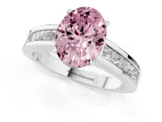 Fancy Pink Oval Cut Diamond Solitaire Ring Set in Platinum with Channel-Set Band and Prong Setting