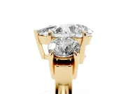 Pear Cut Diamond Three-Stone Ring Set in Yellow gold with Round Accent Stones and Plain Band