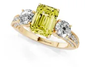 Fancy Yellow Emerald Cut Diamond Three-Stone Ring Set in Yellow gold with Round Side Stones and Pavé Band