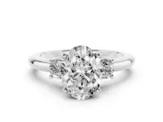Three-Stone Oval Cut Diamond Ring Set in Platinum with Prong Setting and Plain Band