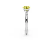 Fancy Yellow Round Cut Diamond Solitaire Ring Set in Platinum with Tapered Baguette Side Stones and Prong Setting