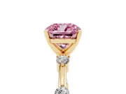 Fancy Pink Cushion Cut Diamond Solitaire Ring Set in Yellow gold with Bezel Set Side Stones and Prong Setting