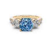 Fancy Blue Three-Stone Cushion Cut Diamond Pavé Band Ring Set in Yellow gold with Prong-Set Trio